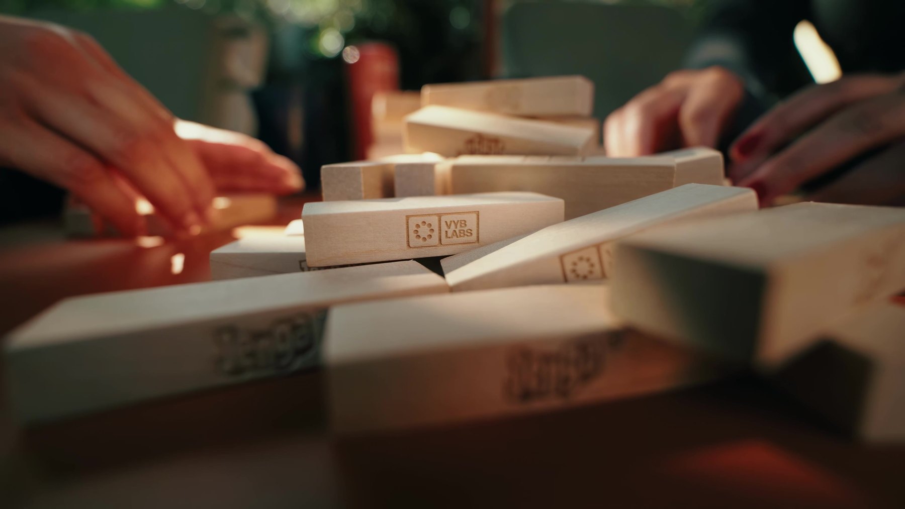 VYB LABS branded Jenga blocks mid game at A Day of Vybrance